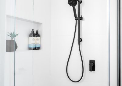 black shower head and taps